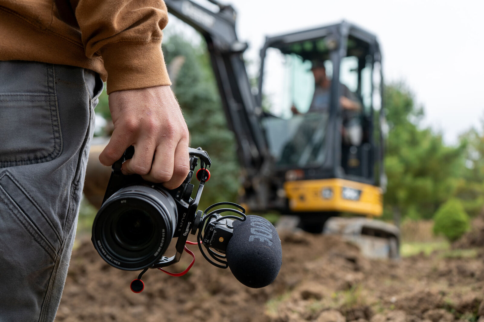 A Third Studio Media videographer capturing branding video of an excavator operator on a job site
